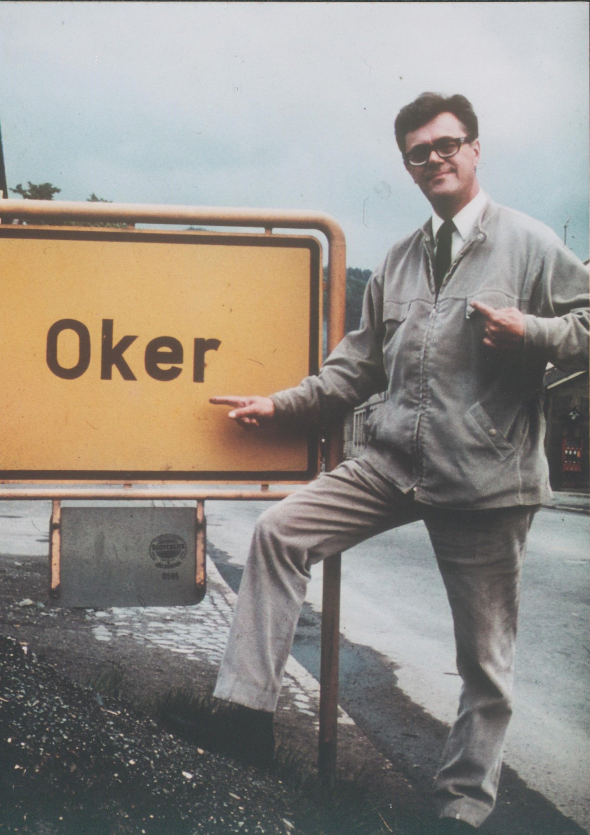 Eugen Oker um 1970 vor dem Ortsschild der Stadt Oker in Niedersachsen.